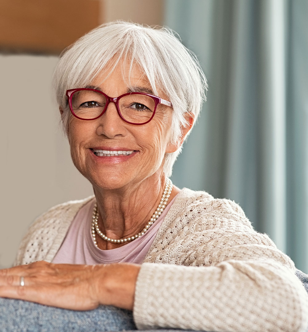 smiling senior woman with dental implants