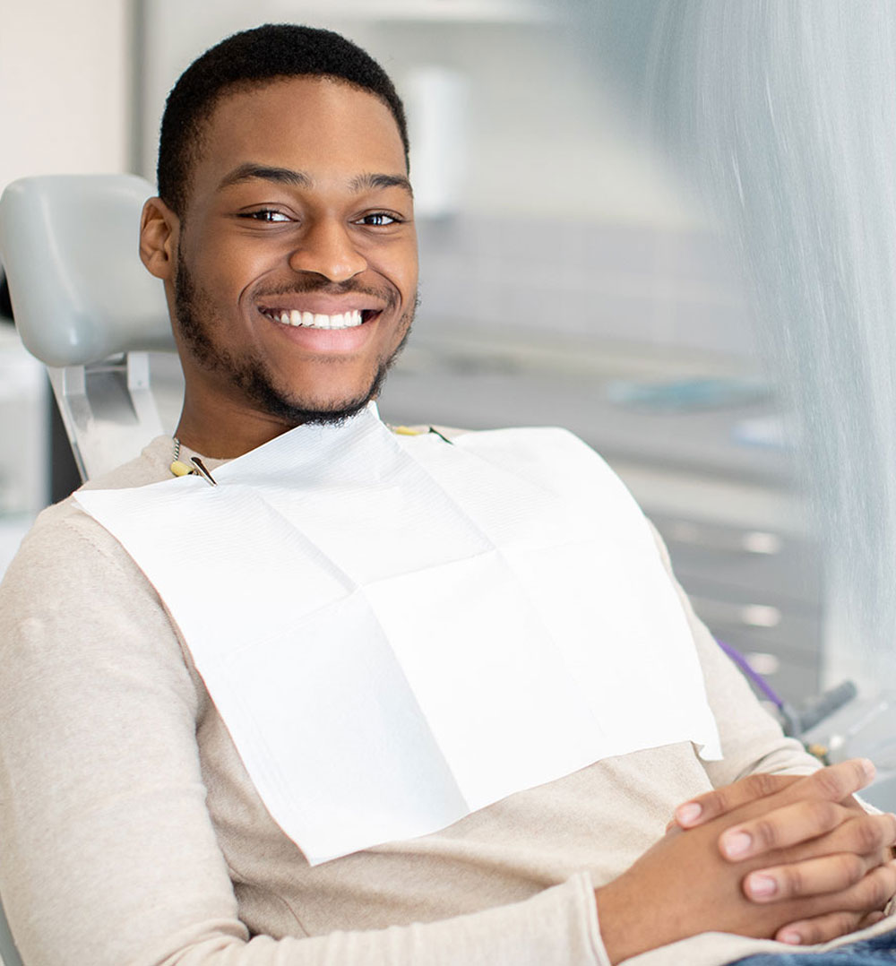 smiling young man getting his wisdom teeth removed